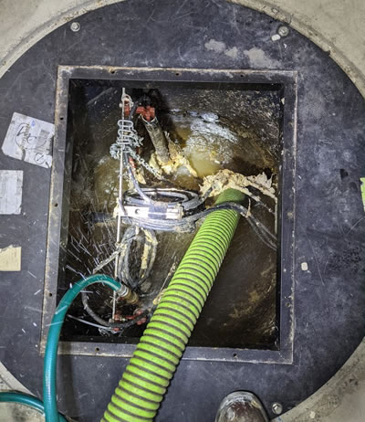 This pump chamber is the typical work environment for a septic dose pump. In this photo we're pumping out the chamber before working on the pump.